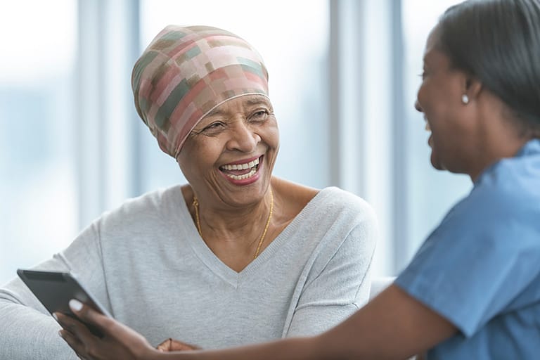 A older woman having a discussion with a nurse.